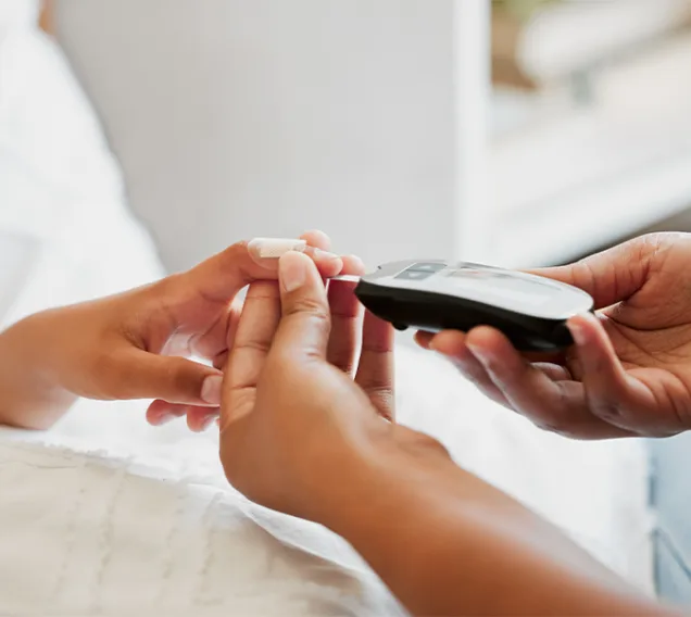 a doctor measuring a child patient's blood sugar